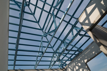 Fototapeta premium Structure of steel roof frame for building construction.