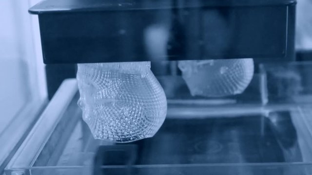 Stereolithography DPL, SLA 3d printer creating shape by UV polymerization. close-up. Progressive modern additive technology 3D printing.