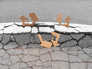 Cracked cardboard houses on cracked land after earthquake destroyed buildings insurance concept