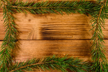 Frame of the fir tree branches on a wooden table