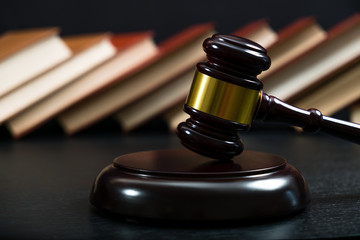 Judge gavel beside pile of books