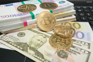 Golden bitcoin coin on us dollars close up - Image. Symbolic image of virtual currency. Business concept of worldwide cryptocurrency.