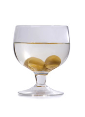 Green olives in glass wine on white background