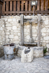 Antique stone fixture with a millstone and a press