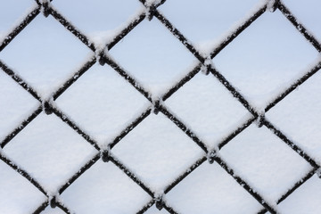abstract grate fence with snow