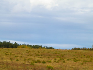 Autumnal field in cloudy day. Poland.
