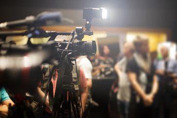 press and cameras recording a conference event