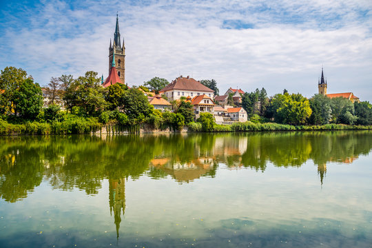 Reflection of church tower on the surface of the pond