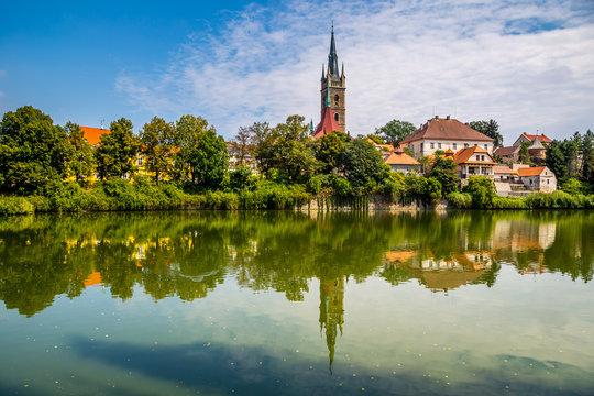 Reflection of church tower on the surface of the pond