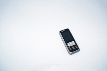 Against the background of white snow mobile phone.