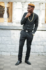 Chic handsome african american man in black shirt with gold chain.