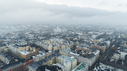 Aerial winter panorama of Helsinki, Finland. Dark snow clouds over the city