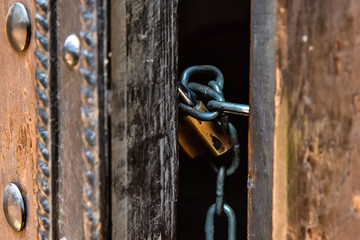 Naklejka premium Closed door by chain and padlock