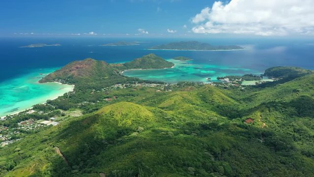 Aerial panoramic view of east coast of Praslin Island, turquoise crystal clear waters of Indian Ocean - Cap Samy, Seychelles