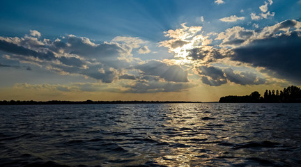 Warm summer sunset over the river Danube on the background of a blue sky