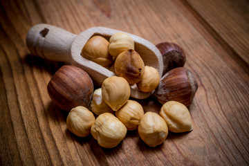 peeled hazelnuts on wooden spoon