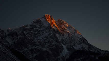 illuminated peak rocks of mountain peak at late evening in tirol