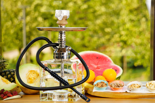 East smoking hookah. Arabian shisha with fruits. Hookah and apple.Trendy hookah
