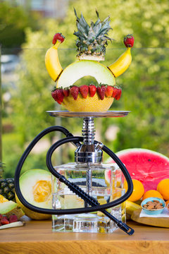 East smoking hookah. Arabian shisha with fruits. Hookah and apple.Trendy hookah