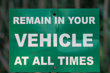 Remain in vehicle warning sign