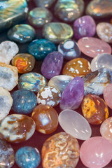 Obraz na płótnie Canvas Heap of various colored gems. Colorful gemstones. Natural Polished Gemstone Semi Precious Rocks Colorful Background Texture Close Up Phot. vertical photo