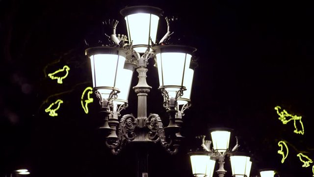 The night streets of the city. Street light with lamps in a classical style. 4K