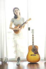 Beautiful girl playing ukulele