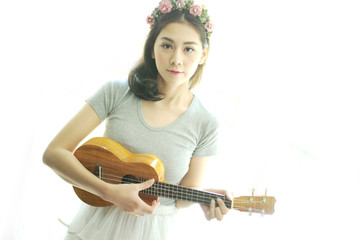 Beautiful girl playing ukulele