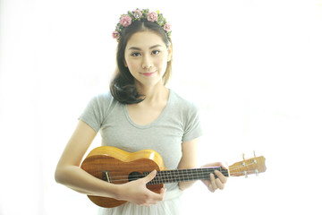 Beautiful girl playing ukulele