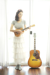 Beautiful girl playing ukulele