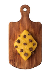 Cookie dough with chocolate chips on a cutting board, top view. Isolated object