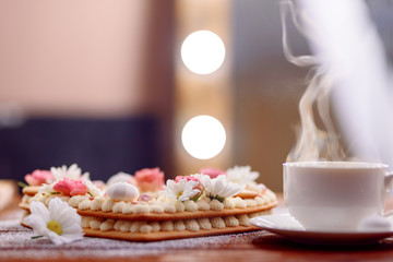 Valentine's Day heart-shaped cake with flowers as decoration. The concept of a gift to a loved one on a holiday.