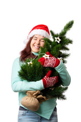 Photo of woman in Santa's cap with Christmas tree in hand