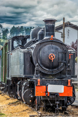 Fototapeta na wymiar Front view of old train with dramatic sky