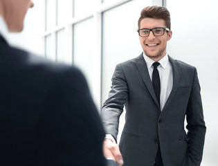 Fototapeta premium Manager greets the client with a handshake.