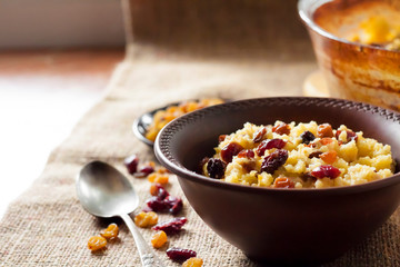 Sweet millet porridge with raisins and dried cranberries