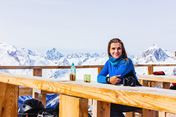 Tourist girl in a cafe on the mountains.
