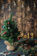 Fototapeta premium Christmas tree with golden numbers 2019 on a wooden background
