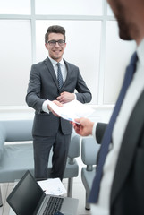 smiling employee, giving a report on the project Manager