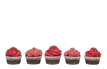 Delicious chocolate cupcakes with red and pink creamy icing on isolated white background. Copy space.
