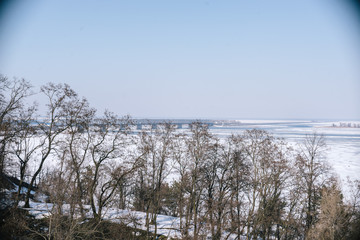 A spring sunny day in a snowy park
