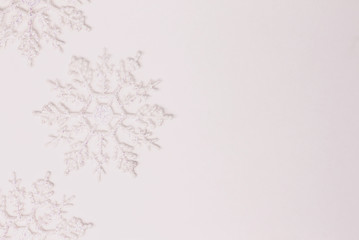 Three shiny white snowflakes on pure white background. Copy paste.