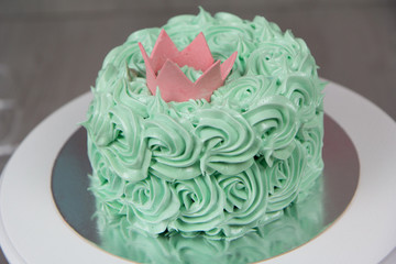 Green cake with crown decor.