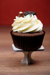 Chocolate, tasty and sweet cupcake with vanilla cream and condensed milk inside
