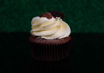 Chocolate, tasty and sweet cupcake with vanilla cream and condensed milk inside. Minimal food bakery concept.