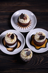 Chocolate, tasty and sweet cupcake with vanilla cream and condensed milk inside. Minimal food bakery concept.