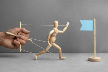 Barriers and deductions on the way to the goal. The puppeteer holds the doll and does not let the...