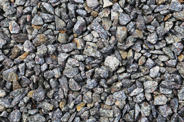 Grey ground stone rubble background of many small stones