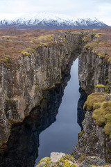 view of lake in abandoned landscape in Iceland, in the background of a snowy mountain