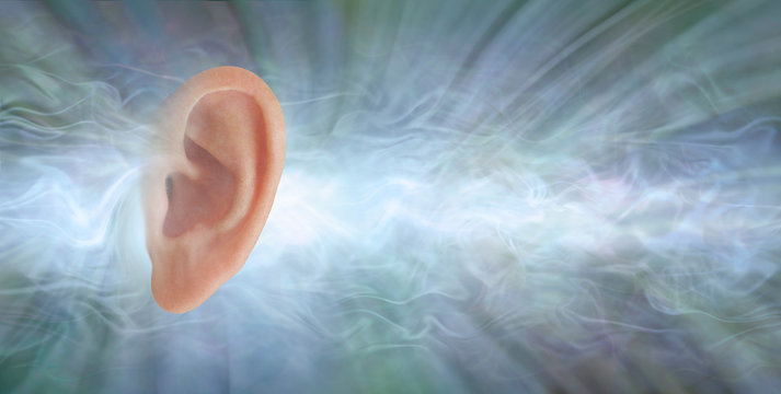 Audiology - if you could see what sound looks like - single flat profile of a human ear isolated against a jade coloured radiating flowing sound waves background with copy space 